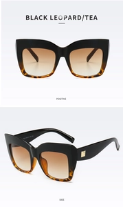 Detail view of black leopard sunglasses with tea gradient lenses and gold accents