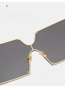 Close-up of soft silicone nose pads on oversized gold metal frame sunglasses