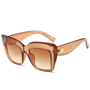 Fashionable oversized amber cat-eye sunglasses with gradient lenses and gold accents