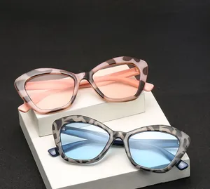 Close-up of leopard print cat-eye sunglasses with metal hinges on white display