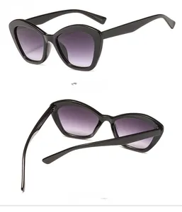 Detail view of glossy black cat eye sunglasses with purple gradient lenses showing 45-degree angle