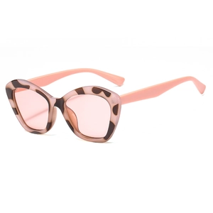 Trendy tortoiseshell cat eye sunglasses with light pink lenses on a white background