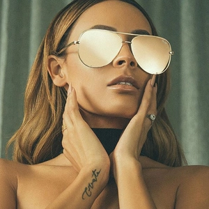 Close-up of golden aviator sunglasses with metal frames and reflective mirrored lenses