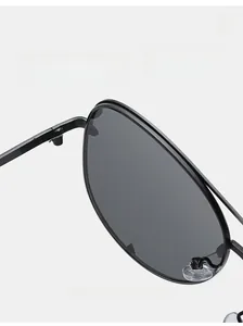 Close-up of durable metal hinges and soft silicone nose pads on classic aviator sunglasses