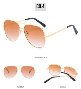 Detailed view of aviator sunglasses with gold metal frame and orange gradient lenses