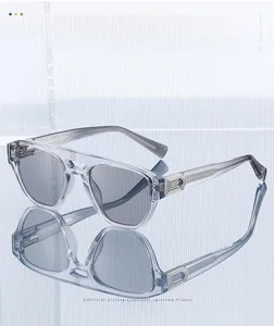 Detailed view of grey transparent pilot sunglasses with double bridge and metal hinges