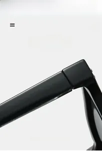 Detail view of smooth black acetate sunglasses frame with high-quality metal hinge