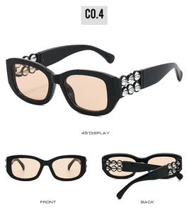 Makroansicht der schwarzen rechteckigen Sonnenbrille mit orangefarbenen Gläsern und Perlen