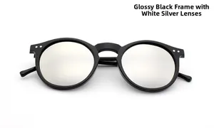 Detail of round black cat eye sunglasses with silver mirrored lenses and metal rivets
