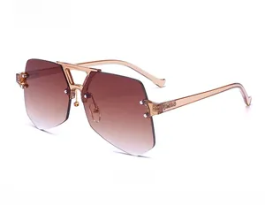 Close-up of frameless oversized sunglasses with brown gradient polygonal lenses and V-metal part