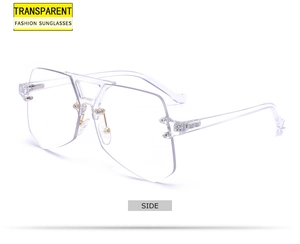 Detail view of transparent rimless sunglasses with gold metal hinges and sleek side design