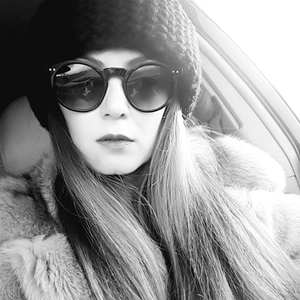 Retro round cat-eye sunglasses with thick frame styled with a knitted beanie and fur coat