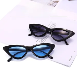 Macro shot of retro cat-eye sunglasses with gradient purple and bright blue lenses