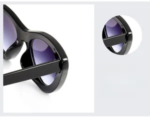Close-up of stylish wide temples and reinforced hinges on black cat-eye sunglasses
