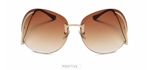 Détail de lunettes de soleil sans monture avec verres dégradés marron et branches dorées fines