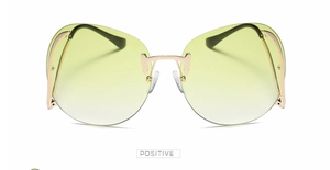 Détail de lunettes de soleil sans monture avec verres dégradés jaunes et pont doré