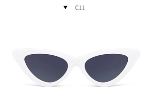 Detail view of white retro cat-eye sunglasses with dark lenses and sleek glossy finish