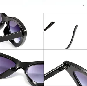 Detail view of thick black frame sunglasses with purple gradient lenses and metal hinges