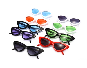 Flat lay of retro triangle cat eye sunglasses in multiple vibrant frame and lens colors