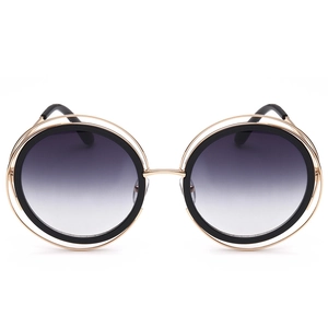 Lunettes de soleil rondes dorées avec structure évidée et verres dégradés style rétro