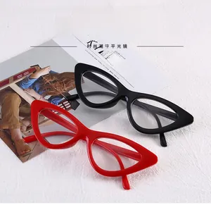 Close-up of stylish red and black cat-eye glasses frames on a fashion magazine