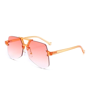 Modern oversized rimless sunglasses with orange gradient lenses in a side view