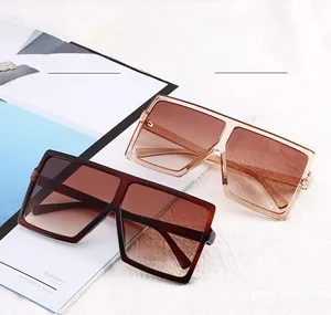 Close-up of oversized square sunglasses with gradient lenses in tortoiseshell and amber