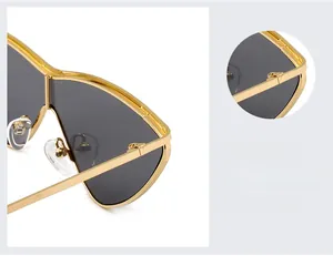 Detail view of gold metal frame hinges and silicone nose pads on gradient sunglasses