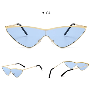 Detail view of cat eye sunglasses with gold metal frame and light blue lenses
