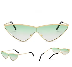Detail view of cat-eye gradient sunglasses with slim gold metal frame and green lenses