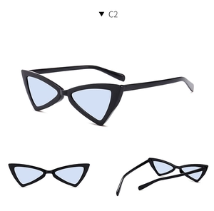 Detail view of cat eye triangle sunglasses with black frame and light blue lenses