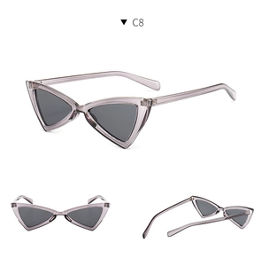 Detail view of triangular cat eye sunglasses with grey-purple frame and dark lenses