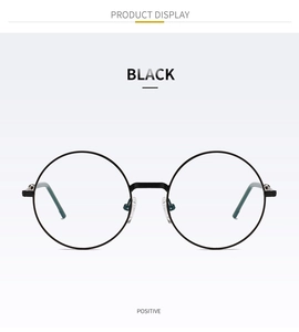 Vue de face de lunettes rondes noires en métal fin de style rétro sur fond blanc épuré