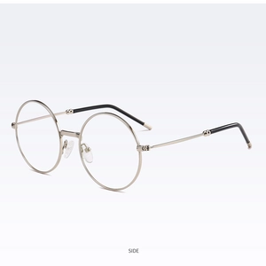 Vue latérale d'une monture de lunettes ronde rétro en métal doré avec bouts noirs