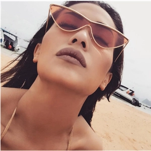 Fashionable women's oversized cat eye sunglasses with gradient orange lenses and gold frame