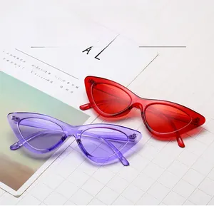 Detailed close-up of red and purple cat-eye sunglasses with transparent resin frames