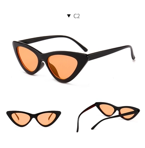Detail view of vintage cat eye sunglasses with sleek black frame and orange lenses