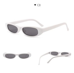 Detail view of small oval white sunglasses with dark grey lenses and C8 model mark