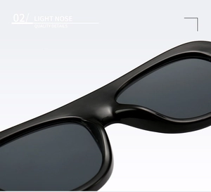 Detail of lightweight integrated nose pads on polished black oversized sunglasses frame