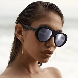 Fashionable oversized black aviator sunglasses with matte frame and dark grey lenses