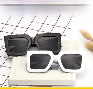 Detail of square oversized sunglasses in black and white colors with thick frames