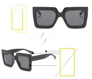 Detail of square oversized black sunglasses with thick frames and fashionable design