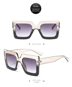 Detail view of square oversized sunglasses with champagne-to-black gradient frames