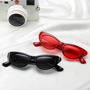 Stylish cat-eye sunglasses with UV protection in red and black on silk background