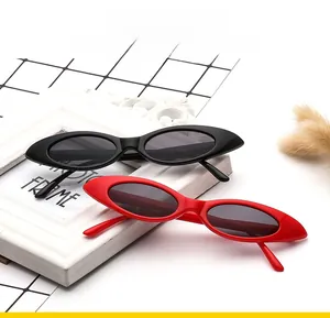 Detail of red and black cat eye sunglasses featuring vintage narrow oval frames