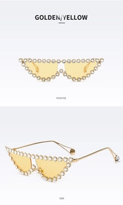 Détail de lunettes de soleil œil-de-chat avec verres jaunes et strass en cristal brillants