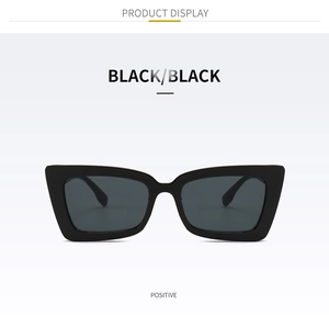 Front view of black oversized square sunglasses with thick frames and dark lenses