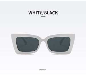 Front view of stylish white rectangular cat-eye sunglasses with dark grey lenses