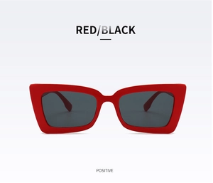 Close-up of retro red thick-frame sunglasses with dark lenses from a front perspective
