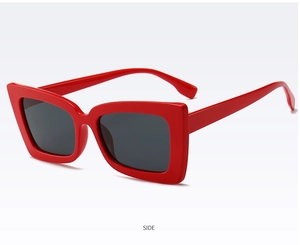 Side view of trendy red thick frame square sunglasses with black tinted lenses